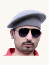 Default grey beret cap made of wool, modeled by a man, available for purchase online