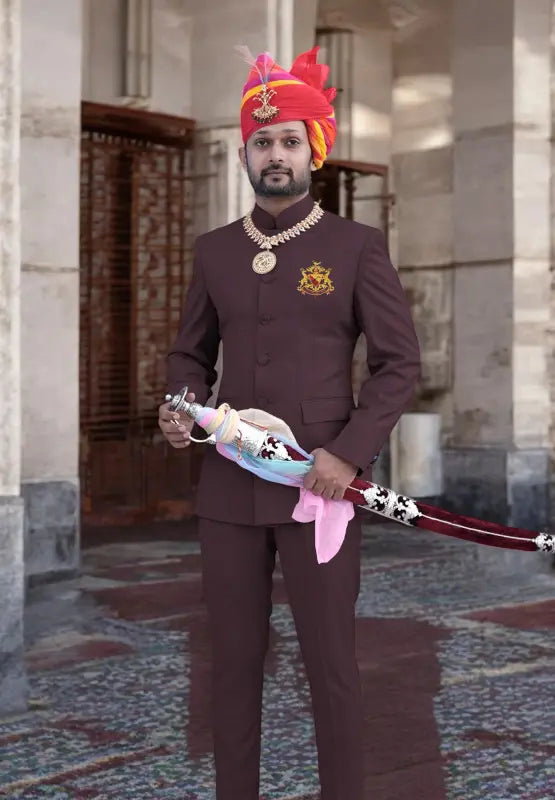 Elegant Bhati Coat Suit for Men in brown with traditional accessories and vibrant pagri