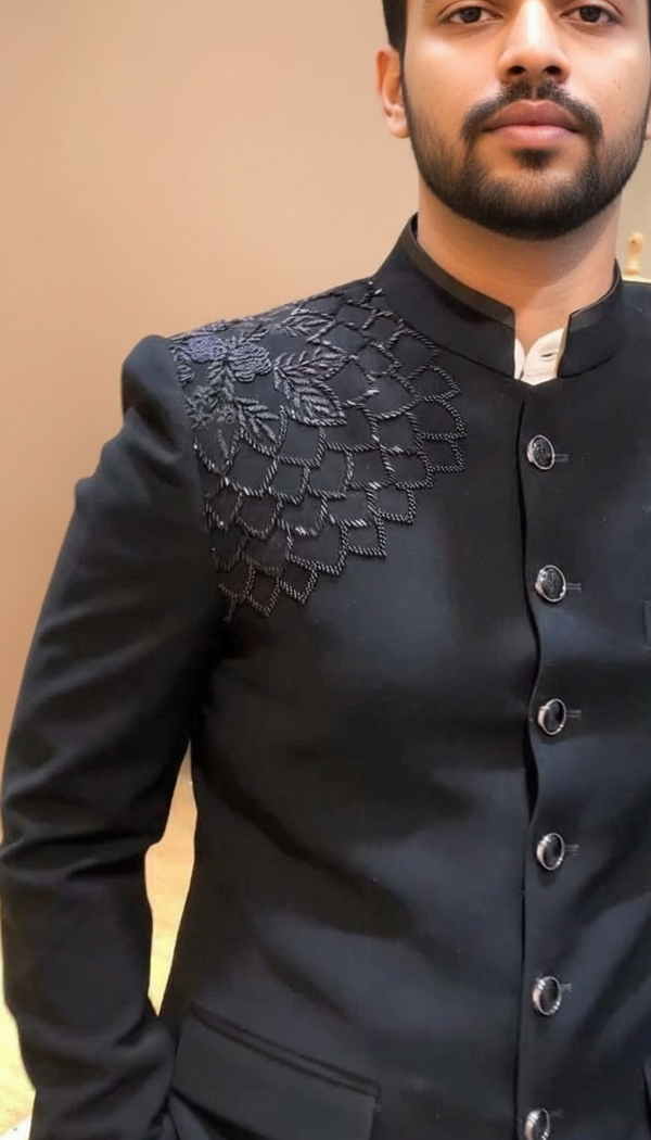 Stylish black embroidered bandhgala suit with intricate floral design on the shoulder
