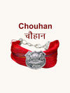 Chouhan logo bracelet and moli featuring colorful threads and a decorative shield emblem