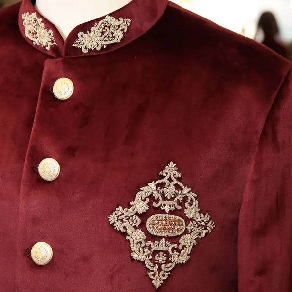 Exclusive men's designer coat in burgundy velvet with intricate embroidery and decorative buttons