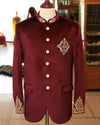 Exclusive men's designer coat in burgundy velvet with intricate embroidery and button details