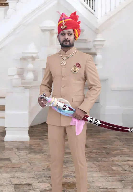 Elegant beige gents suit for wedding with traditional accessories and a colorful turban