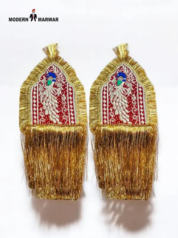 Pair of gold embroidered epaulettes featuring intricate designs and fringed edges for traditional attire
