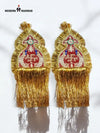 Gold epaulette accessories with intricate design and fringed edges for traditional attire.