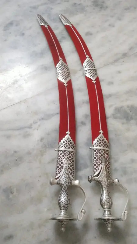 Traditional heritage Indian talwar for home décor featuring intricate silver detailing and red blades