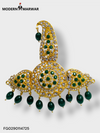 Traditional Indian wedding jewelry featuring intricate gold design with green gemstones and pearl accents