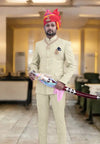 Elegant Jodhpuri suit for men in cream color, featuring a royal turban and regal accessories