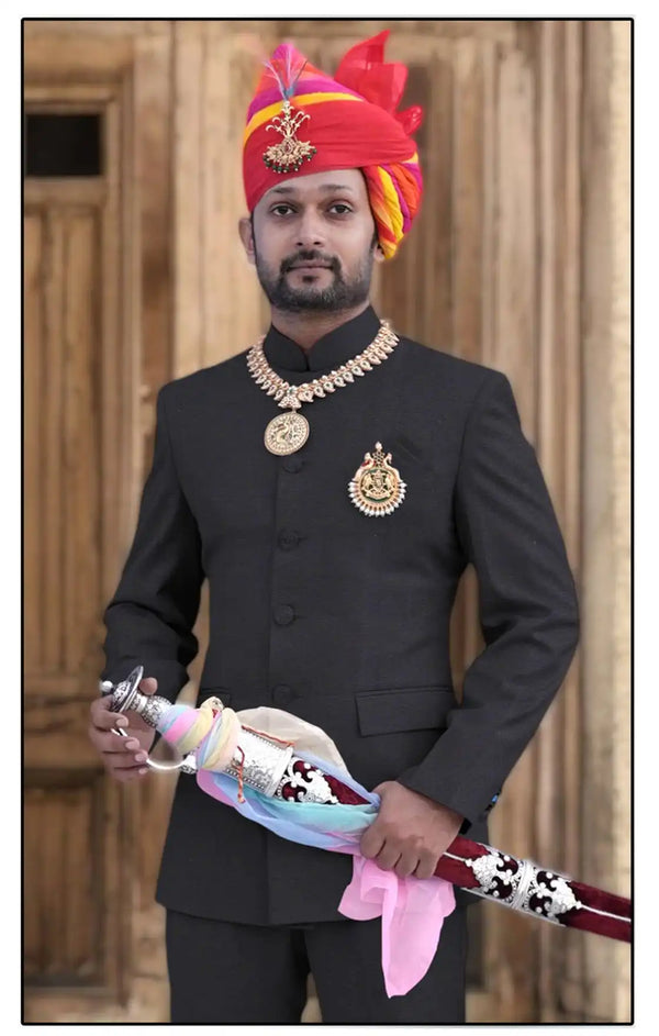 Elegant Jodhpuri suit for men worn with traditional accessories and a vibrant turban