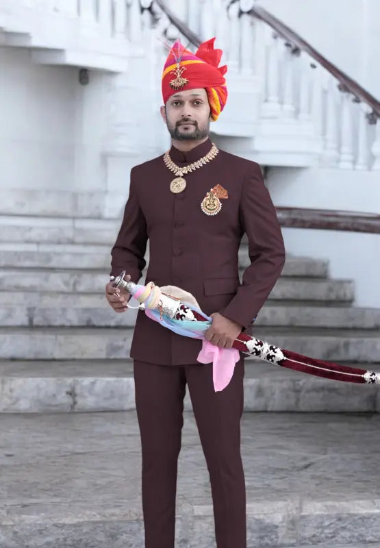 Elegant Jodhpuri suit for men in rich maroon with traditional turbans and accessories