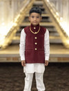 Elegant kids velvet koti in maroon with button details and layered over a white kurta for festive occasions