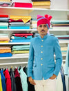 Man in blue M Jodhpuri suit with gold buttons, showcasing a luxury men's velvet coat from Modern Marwar
