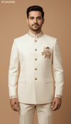 Men's Jodhpuri coat with elephant logo in cream color, featuring intricate embroidery and traditional buttons.