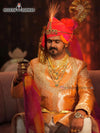 Elegant men's sherwani angarkha in peach with intricate embroidery and vibrant accessories