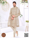 Elegant wedding groom sherwani set in beige with intricate embroidery and matching accessories