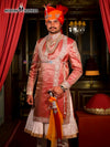 Elegant designer angarkha sherwani for men in pink with intricate embroidery and traditional accessories
