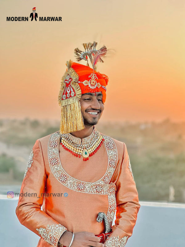Men's sherwani angarkha in peach with intricate embroidery and royal accessories for festive occasions