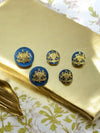 Set of five elegant premium coat buttons with intricate golden designs on a blue background