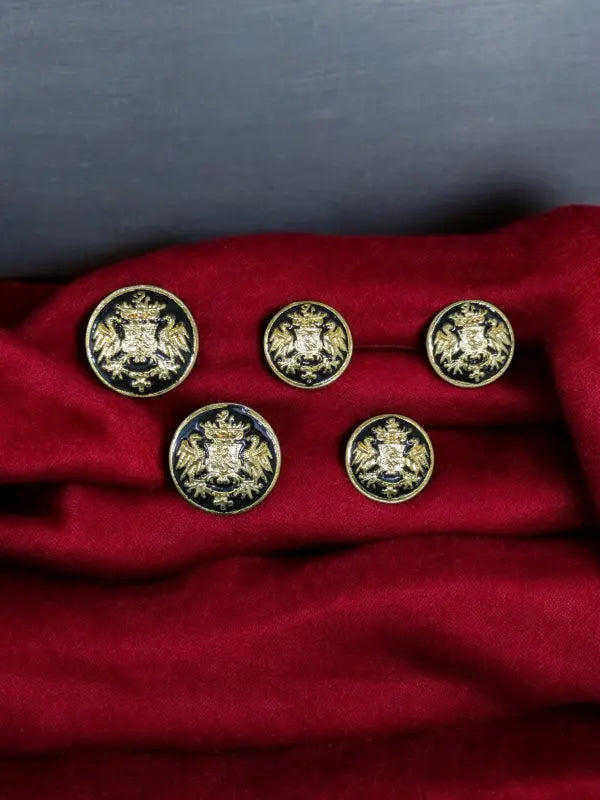 Set of five Rathore logo buttons online on a luxurious red fabric background