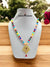 Colorful traditional necklace with pendant featuring beads and a decorative charm, perfect for festive occasions