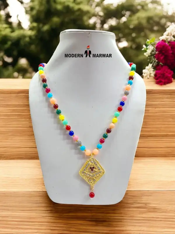 Colorful traditional necklace with pendant featuring beads and a decorative charm, perfect for festive occasions