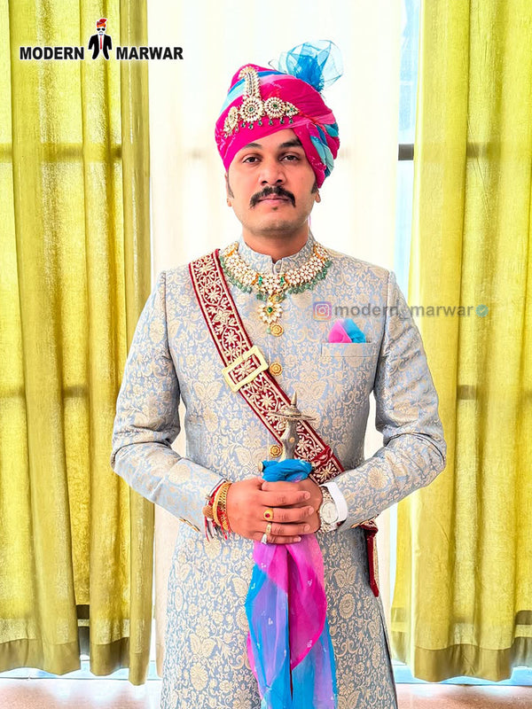 Elegant wedding groom sherwani in beige with intricate designs and colorful accessories