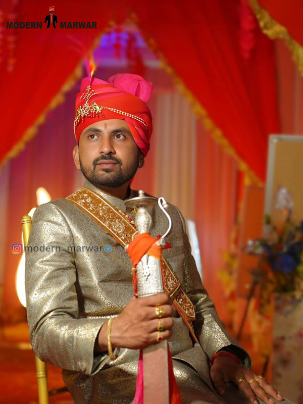Stylish wedding groom sherwani in gold with traditional turban and sword, perfect for Indian weddings