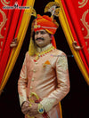 Elegant wedding groom sherwani in peach with intricate embroidery and traditional accessories
