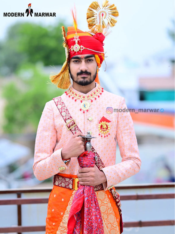 Traditional wedding groom sherwani in peach with intricate embroidery and matching accessories
