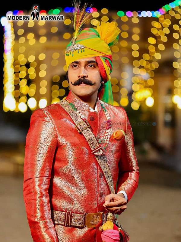 Stunning wedding groom sherwani in red with intricate patterns and traditional accessories for a festive look