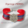 Parmar logo moli bracelet with vibrant red and colorful threads, featuring a decorative silver emblem