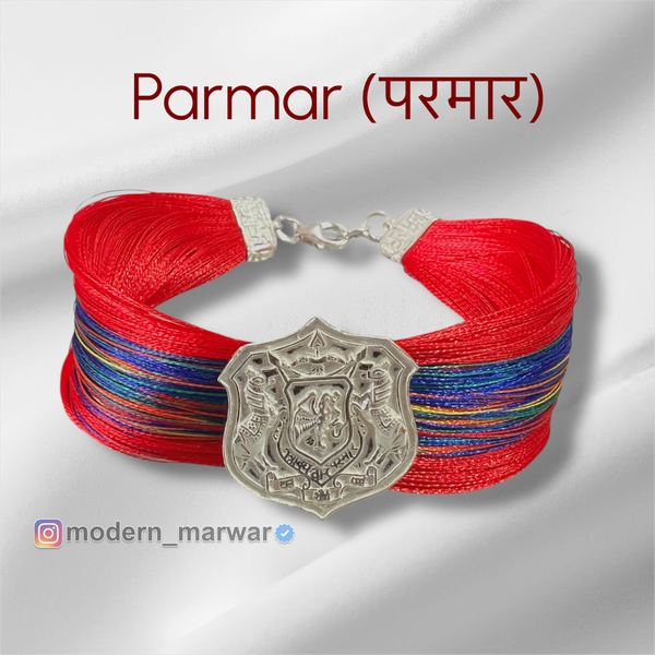 Parmar logo moli bracelet with vibrant red and colorful threads, featuring a decorative silver emblem