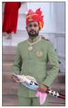 Elegant Rajputi Jodhpuri Suit in green worn by a man, paired with traditional accessories