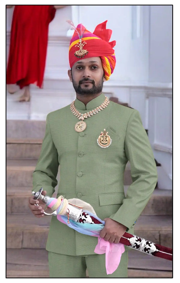 Elegant Rajputi Jodhpuri Suit in green worn by a man, paired with traditional accessories