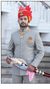 Elegant Rajputi Jodhpuri Suit for men with intricate buttons and a matching turban, ideal for royal events