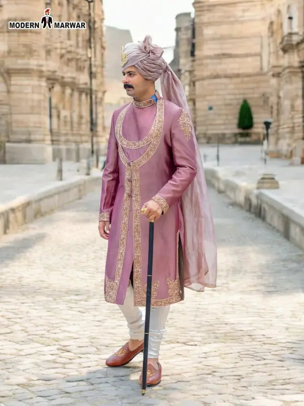Model wearing a pink Sherwani Angarkha traditional wear with intricate embroidery and a stylish turban