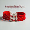 Sisodiya/ Chundawat logo moli bracelet in red braided design featuring a silver emblem