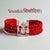 Sisodiya/ Chundawat logo moli bracelet in red braided design featuring a silver emblem