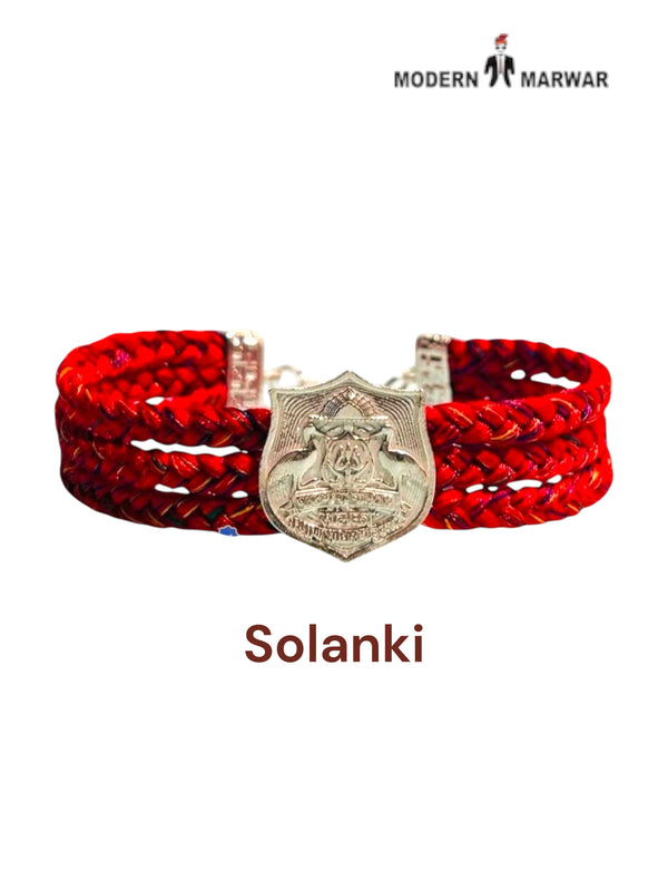 Default red braided fabric bracelet shown from the front featuring the Solanki logo moli bracelet