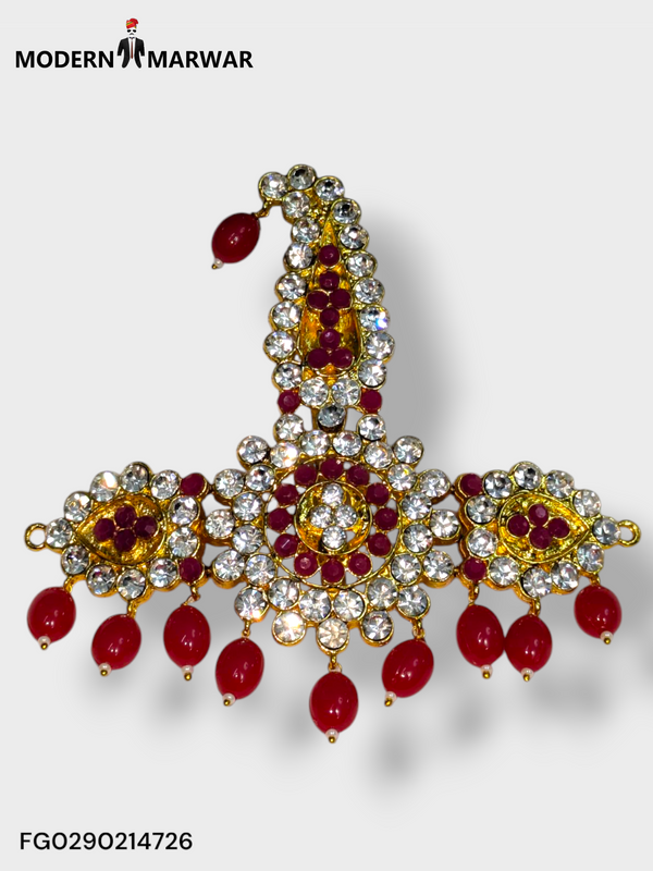 Traditional bejeweled brooch featuring intricate designs and vibrant red stones by Modern Marwar