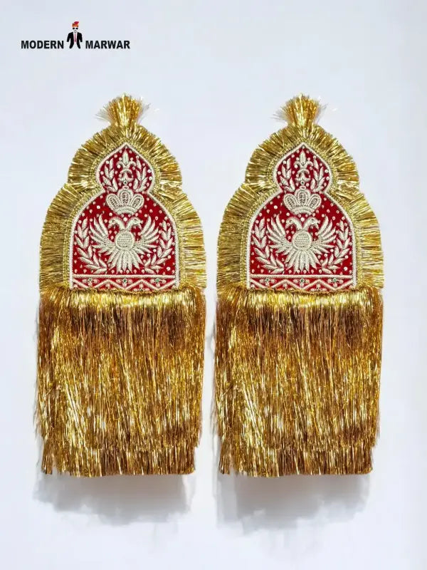 Traditional epaulette accessories in gold and red with intricate embroidery and tassels