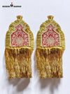 Elegant traditional epaulette accessory in gold and red with intricate designs for ceremonial attire