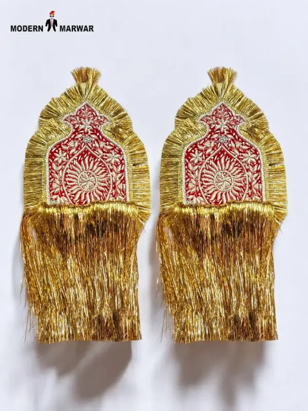 Elegant traditional epaulette accessory in gold and red with intricate designs for ceremonial attire