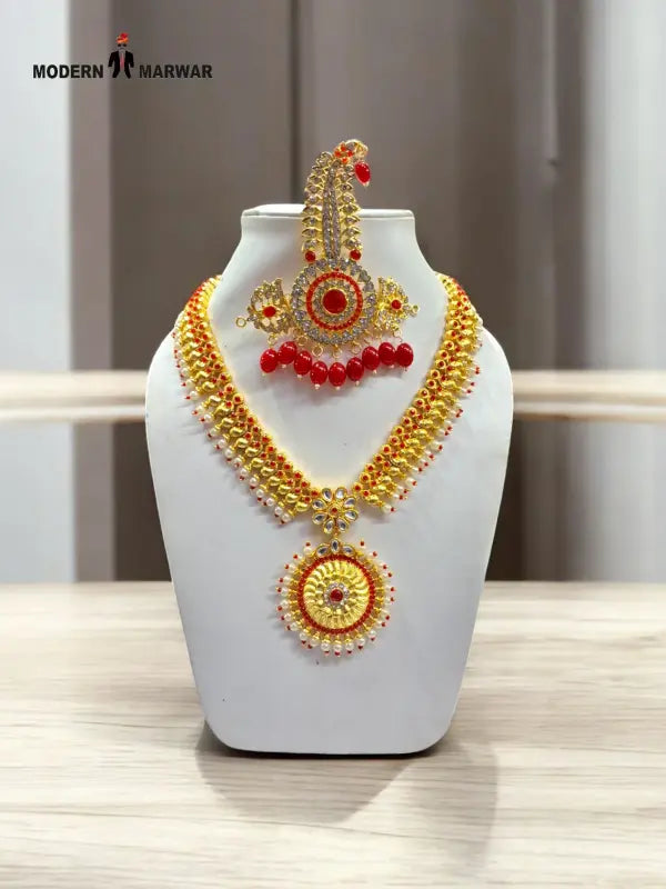 Traditional jewelry set by Modern Marwar featuring intricate designs with gold and red accents
