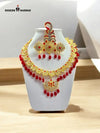 Stunning traditional jewelry set with intricate gold plating and red gemstone accents for festive occasions