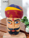 Colorfully hand-painted traditional safa for weddings worn by a decorative figurine