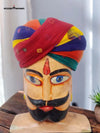 Vibrant traditional safa turban displayed on a decorative bust with intricate hand-painted features