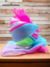 Colorful traditional safa turban styled on a mannequin head with vibrant pink and blue shades