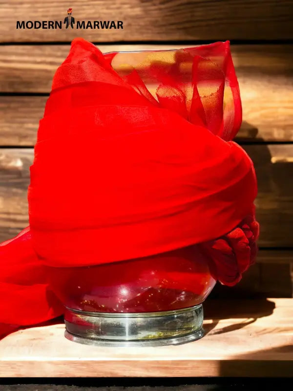 Modern Marwar Red Traditional Safa Turban Draped Elegantly Over a Glass Pot