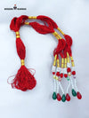 Traditional talwar dori in vibrant red with decorative beads and tassels for ceremonial use